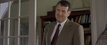 Movie still from “In the Bedroom” (2001), directed by Todd Field – A person wearing a suit and tie; Close Up shot, Over the shoulder angle