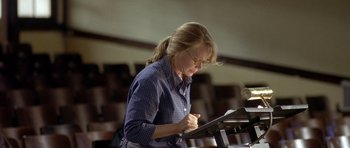 Movie still from “In the Bedroom” (2001), directed by Todd Field – A woman is writing on a piece of paper; Medium shot, Low angle