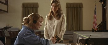 Movie still from “In the Bedroom” (2001), directed by Todd Field – Two women standing at a table looking at a book; Medium shot, Over the shoulder angle