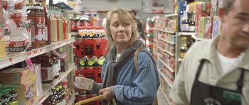 Movie still from “In the Bedroom” (2001), directed by Todd Field – A woman is holding an item in a store; Close Up shot, Low angle