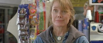 Movie still from “In the Bedroom” (2001), directed by Todd Field – A person wearing a necklace and looking at the camera; Close Up shot, Over the shoulder angle