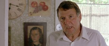 Movie still from “In the Bedroom” (2001), directed by Todd Field – An older man standing in front of a painting; Close Up shot, Over the shoulder angle