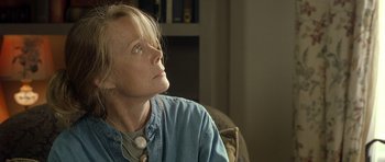 Movie still from “In the Bedroom” (2001), directed by Todd Field – A woman sitting in a chair with her head tilted to the side; Close Up shot, Low angle