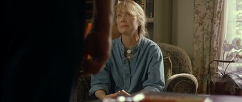 Movie still from “In the Bedroom” (2001), directed by Todd Field – An older woman sitting on a couch looking at someone; Medium shot, Over the shoulder angle