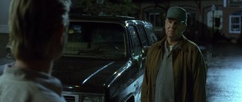 Movie still from “In the Bedroom” (2001), directed by Todd Field – An older man standing in front of an suv; Medium shot, Low angle