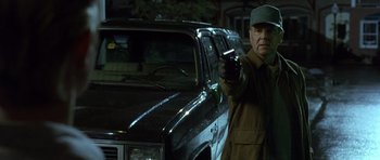 Movie still from “In the Bedroom” (2001), directed by Todd Field – An older man standing next to an old car; Medium shot, Low angle