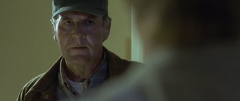 Movie still from “In the Bedroom” (2001), directed by Todd Field – An older man wearing a hat looking at the camera; Close Up shot, Over the shoulder angle