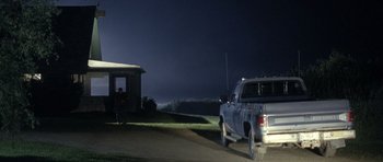 Movie still from “In the Bedroom” (2001), directed by Todd Field – A truck parked on the side of a road at night; Extreme Wide shot, Low angle