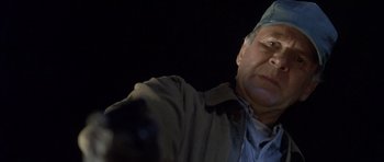 Movie still from “In the Bedroom” (2001), directed by Todd Field – An older man wearing a surgical hat and a coat; Close Up shot, Low angle