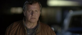 Movie still from “In the Bedroom” (2001), directed by Todd Field – A person wearing a brown jacket; Close Up shot, Over the shoulder angle