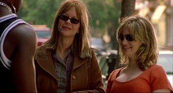 Movie still from “In the Cut” (2003), directed by Jane Campion – A woman and a girl standing next to each other on a sidewalk; Medium shot, Over the shoulder angle