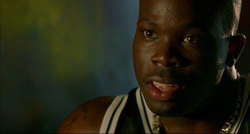 Movie still from “In the Cut” (2003), directed by Jane Campion – A man's face in a basketball uniform; Close Up shot, High angle