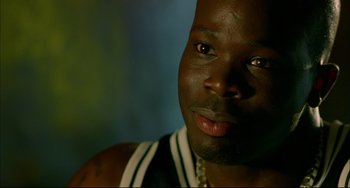 Movie still from “In the Cut” (2003), directed by Jane Campion – A man's face in a dark room; Close Up shot, High angle