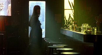 Movie still from “In the Cut” (2003), directed by Jane Campion – A woman standing in front of a counter in a restaurant; Wide shot, Low angle