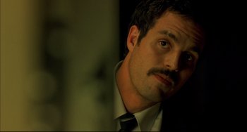 Movie still from “In the Cut” (2003), directed by Jane Campion – A person wearing a suit and tie; Close Up shot, Low angle