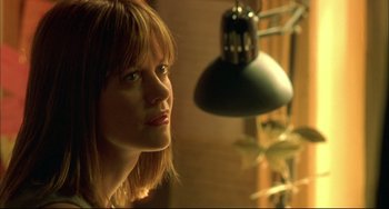 Movie still from “In the Cut” (2003), directed by Jane Campion – A person looking at a lamp; Close Up shot, Low angle