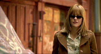 Movie still from “In the Cut” (2003), directed by Jane Campion – A woman wearing sunglasses walking down a street; Close Up shot, Over the shoulder angle
