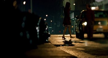 Movie still from “In the Cut” (2003), directed by Jane Campion – A woman walking down a street at night; Wide shot, Low angle