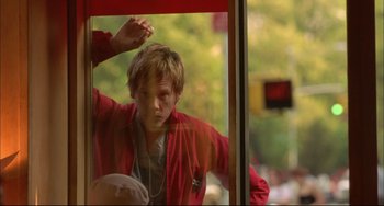 Movie still from “In the Cut” (2003), directed by Jane Campion – A man in a red jacket looking out of a window; Medium shot, Low angle