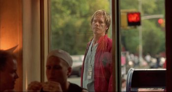 Movie still from “In the Cut” (2003), directed by Jane Campion – A man standing in front of a window; Medium shot, Over the shoulder angle