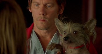 Movie still from “In the Cut” (2003), directed by Jane Campion – A person holding a dog; Close Up shot, Over the shoulder angle