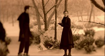 Movie still from “In the Cut” (2003), directed by Jane Campion – A man and a woman standing in the snow; Medium shot, Over the shoulder angle
