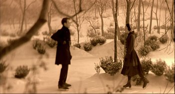 Movie still from “In the Cut” (2003), directed by Jane Campion – A man and a woman standing next to each other in the snow; Wide shot, High angle