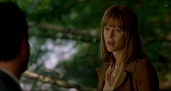 Movie still from “In the Cut” (2003), directed by Jane Campion – A woman in a brown jacket standing in front of a tree; Close Up shot, Over the shoulder angle