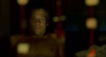Movie still from “In the Cut” (2003), directed by Jane Campion – A man with no shirt in a dark room; Close Up shot, Overhead angle