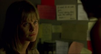 Movie still from “In the Cut” (2003), directed by Jane Campion – A woman is looking at the camera in front of a bunch of papers; Close Up shot, Over the shoulder angle