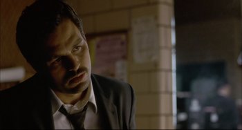 Movie still from “In the Cut” (2003), directed by Jane Campion – A man wearing a suit and tie looking down; Close Up shot, Over the shoulder angle