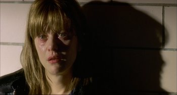 Movie still from “In the Cut” (2003), directed by Jane Campion – A young woman with a bruised face in a dark room; Close Up shot, Over the shoulder angle