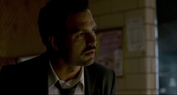 Movie still from “In the Cut” (2003), directed by Jane Campion – A man wearing a suit and tie looking to his left; Close Up shot, Over the shoulder angle