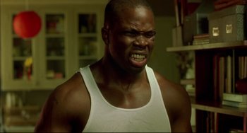Movie still from “In the Cut” (2003), directed by Jane Campion – A man with a white tank top is angry; Close Up shot, Low angle