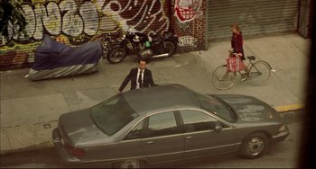 Movie still from “In the Cut” (2003), directed by Jane Campion – A man standing on the hood of a parked car; Extreme Wide shot, High angle