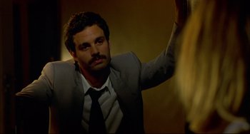 Movie still from “In the Cut” (2003), directed by Jane Campion – A man in a gray suit and a black neck tie; Close Up shot, Over the shoulder angle