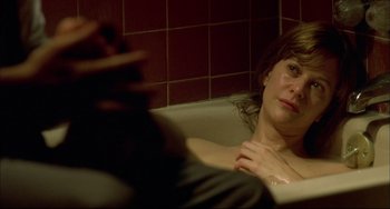 Movie still from “In the Cut” (2003), directed by Jane Campion – A woman sitting in a bath tub in a bathroom; Close Up shot, High angle