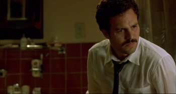 Movie still from “In the Cut” (2003), directed by Jane Campion – A man in a white dress shirt and a black neck tie; Close Up shot, Low angle