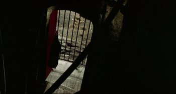 Movie still from “In the Cut” (2003), directed by Jane Campion – A view of a red gate from the ground; Wide shot, Low angle