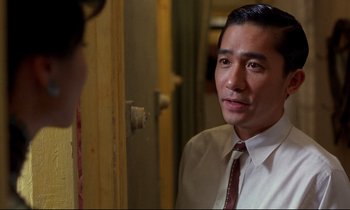 Movie still from “In the Mood for Love” (2000), directed by Kar-Wai Wong – A man wearing a white dress shirt and a tie; Close Up shot, Over the shoulder angle