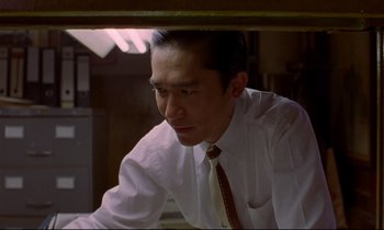 Movie still from “In the Mood for Love” (2000), directed by Kar-Wai Wong – A man wearing a white dress shirt and a tie; Close Up shot, Low angle