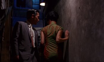 Movie still from “In the Mood for Love” (2000), directed by Kar-Wai Wong – A man and a woman standing next to each other; Medium shot, Over the shoulder angle