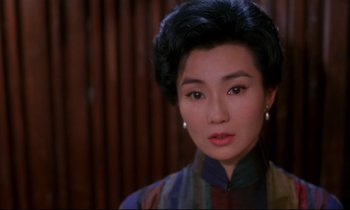 Movie still from “In the Mood for Love” (2000), directed by Kar-Wai Wong – A person wearing a dress; Close Up shot, Over the shoulder angle