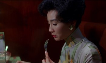 Movie still from “In the Mood for Love” (2000), directed by Kar-Wai Wong – A woman holding a fork in her right hand; Close Up shot, High angle