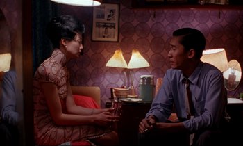 Movie still from “In the Mood for Love” (2000), directed by Kar-Wai Wong – A man and a woman sitting in a living room talking; Medium shot, Over the shoulder angle