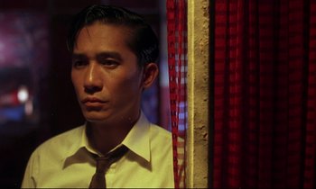 Movie still from “In the Mood for Love” (2000), directed by Kar-Wai Wong – A man wearing a white dress shirt and a tie; Close Up shot, Low angle