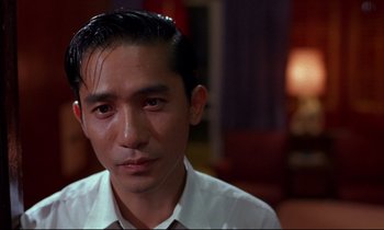 Movie still from “In the Mood for Love” (2000), directed by Kar-Wai Wong – A person wearing a shirt and tie; Close Up shot, Low angle