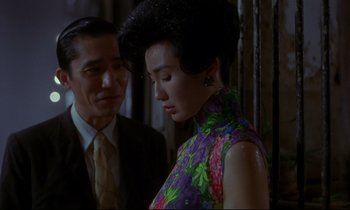 Movie still from “In the Mood for Love” (2000), directed by Kar-Wai Wong – A man and a woman standing next to each other; Medium shot, Over the shoulder angle