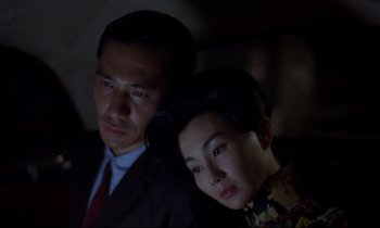 Movie still from “In the Mood for Love” (2000), directed by Kar-Wai Wong – A man and a woman posing for a picture; Close Up shot, High angle