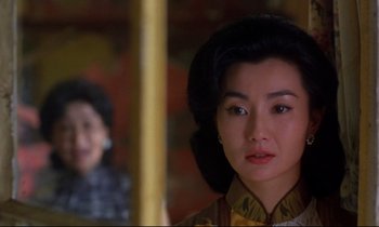 Movie still from “In the Mood for Love” (2000), directed by Kar-Wai Wong – A person with a mirror; Close Up shot, Over the shoulder angle